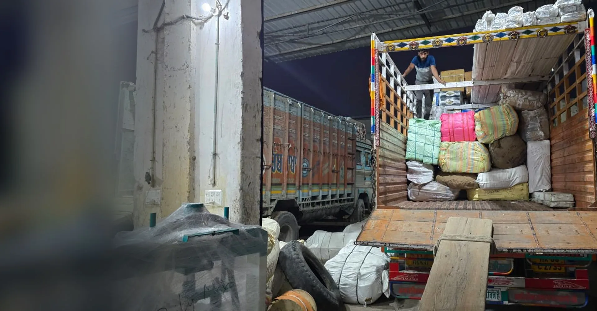 Parcels and bales being loaded into a Shimla Manali Goods Carrier truck after booking